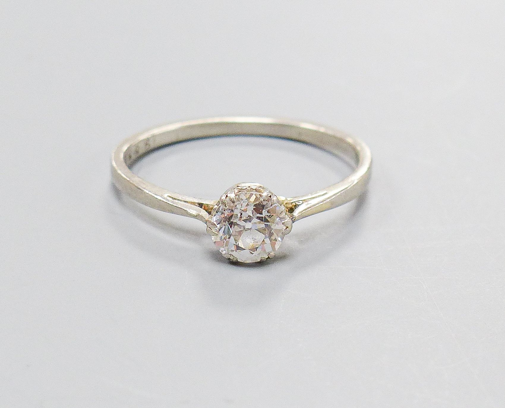 A white metal and solitaire diamond set ring, size K/L, gross weight 2.4 grams